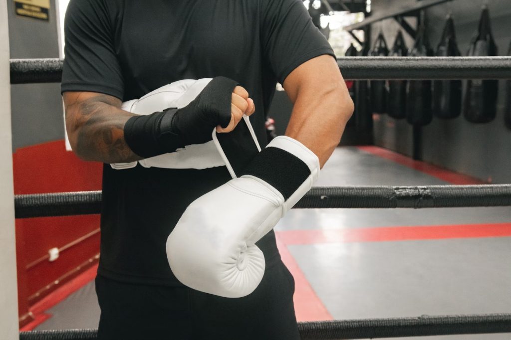 Man putting on gloves getting ready to take action representing discipline.