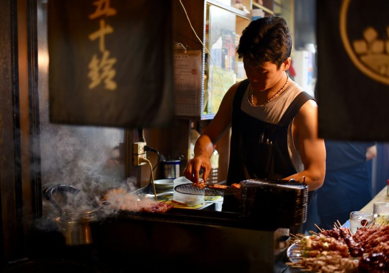 Man preparing a clean meal with steak, eggs, and vegetables—clean eating for strength and focus.