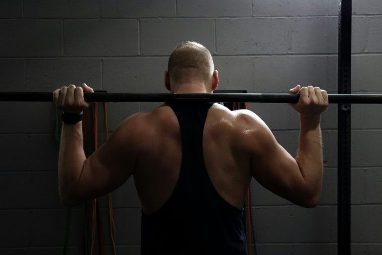 Man training alone in gym – beginner strength training inspiration.
