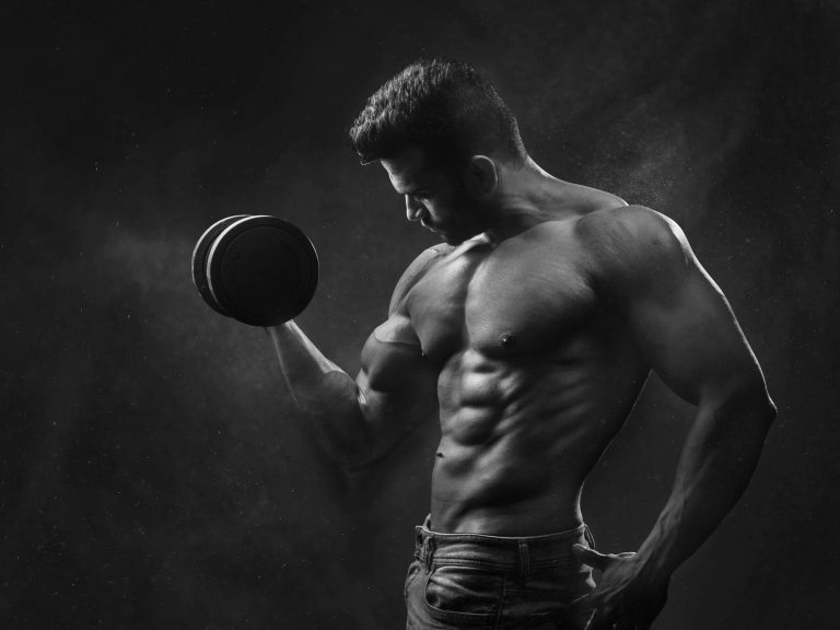 Man embracing physical pain and mental strength during intense workout – symbolic of mental strength and discipline.