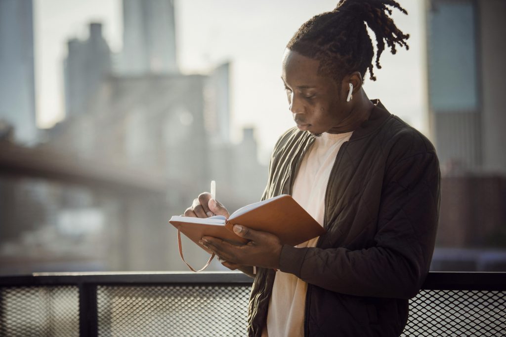 A man journaling due to his newfound ability to focus.