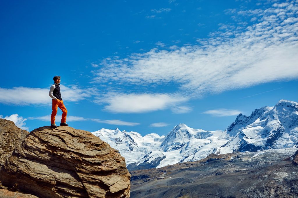 A man standing on top of a mountain, symbolizing .